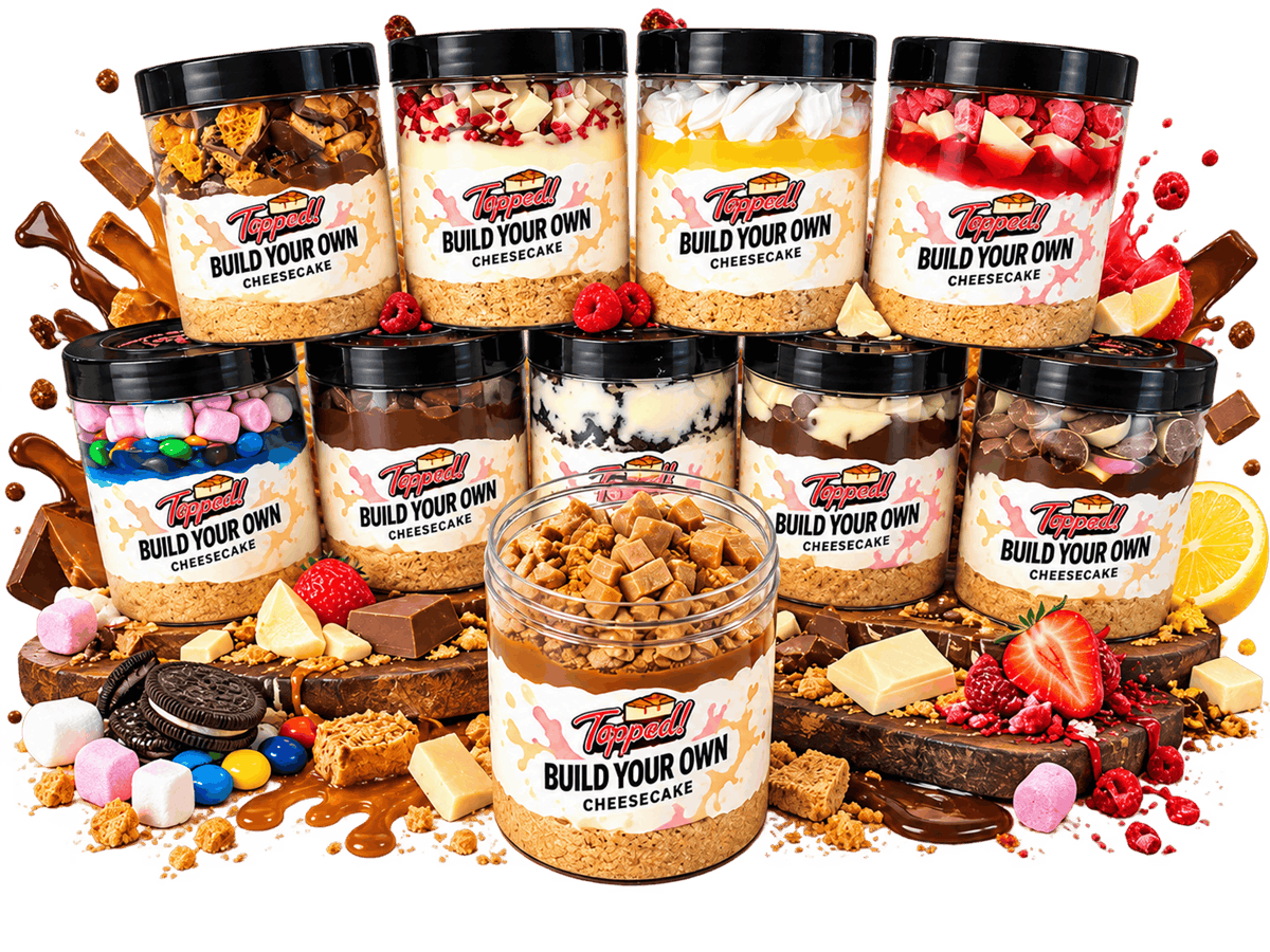 A delicious cheesecake jar with layers of biscuit, cream, and toppings.